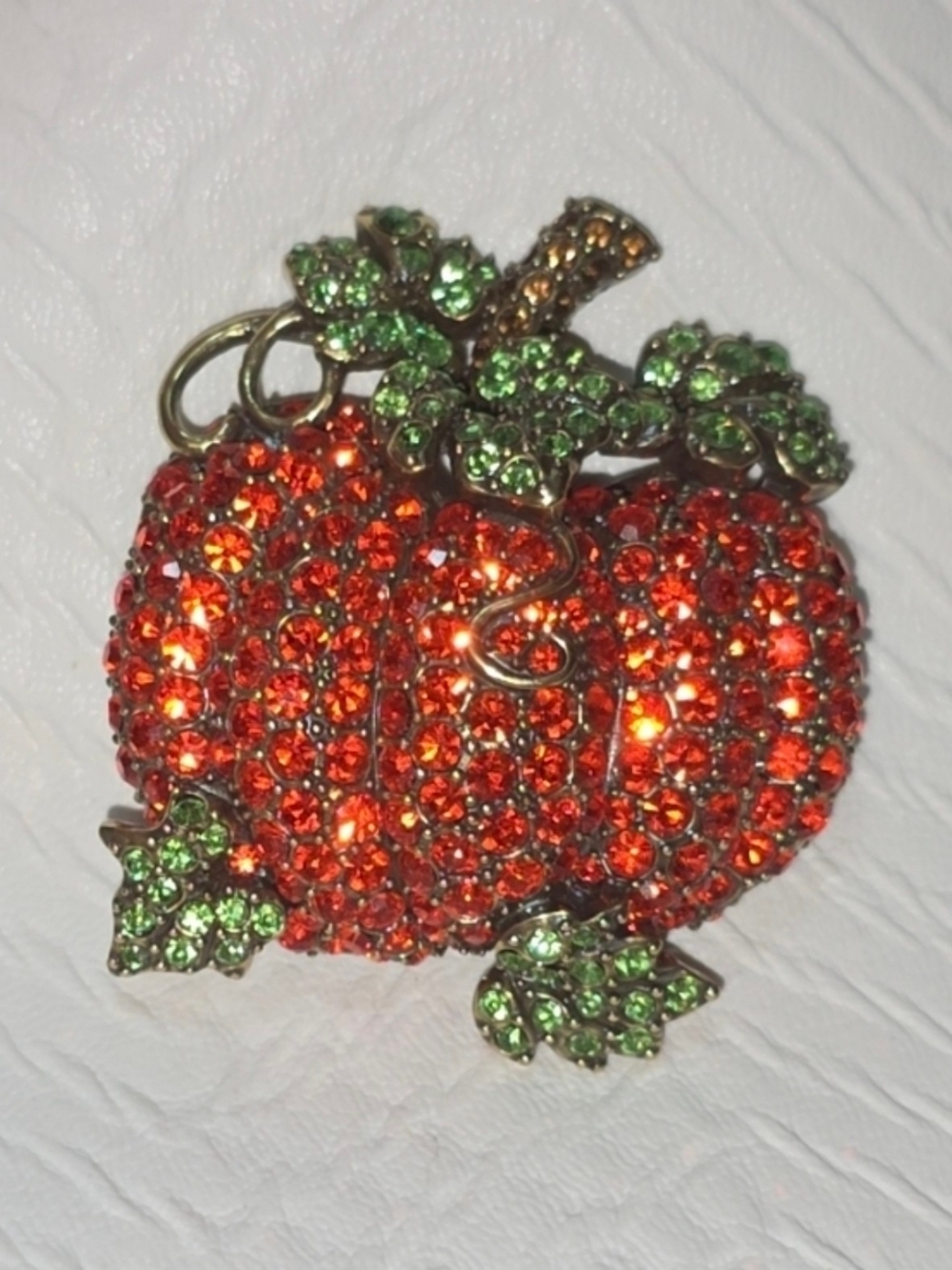 Sparkling Pumpkin Brooch with Green Leaf Accents